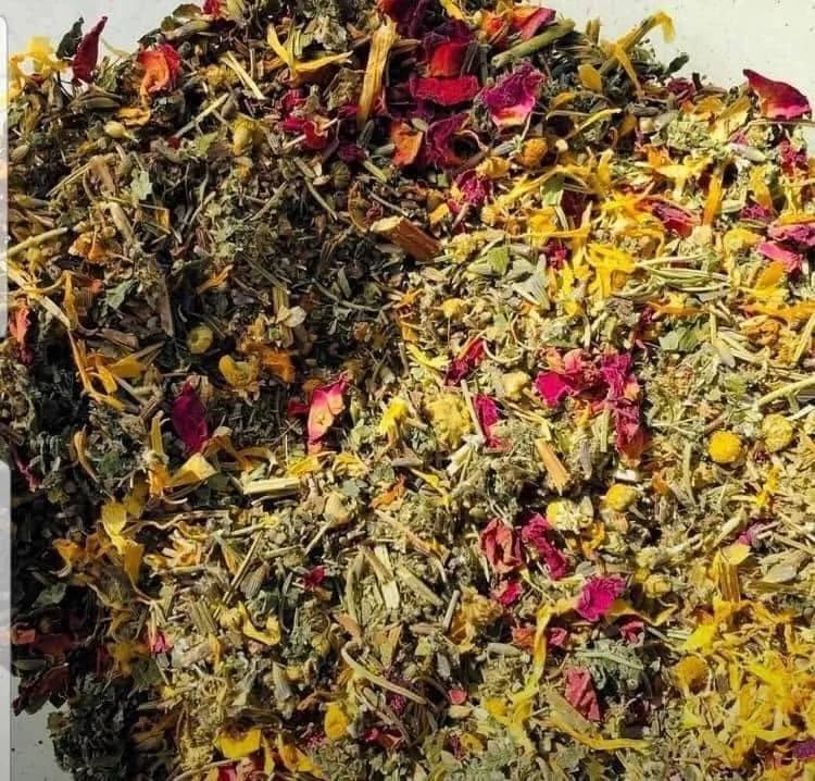 Herbal tea being poured into a ceramic cup